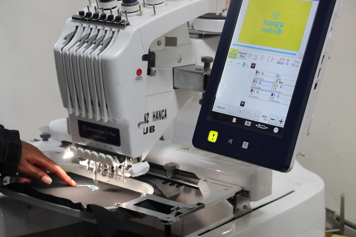 Embroidery machine applying logos to workwear